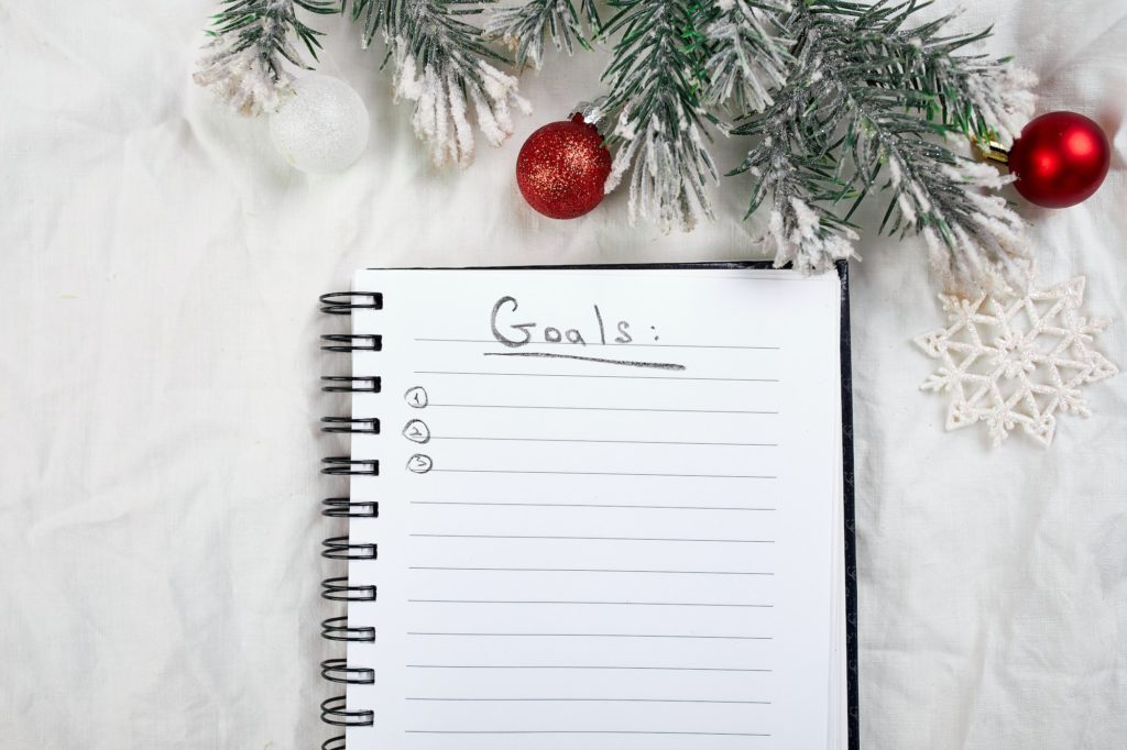 Top view of blank notebook for goals resolutions and christmas decoration